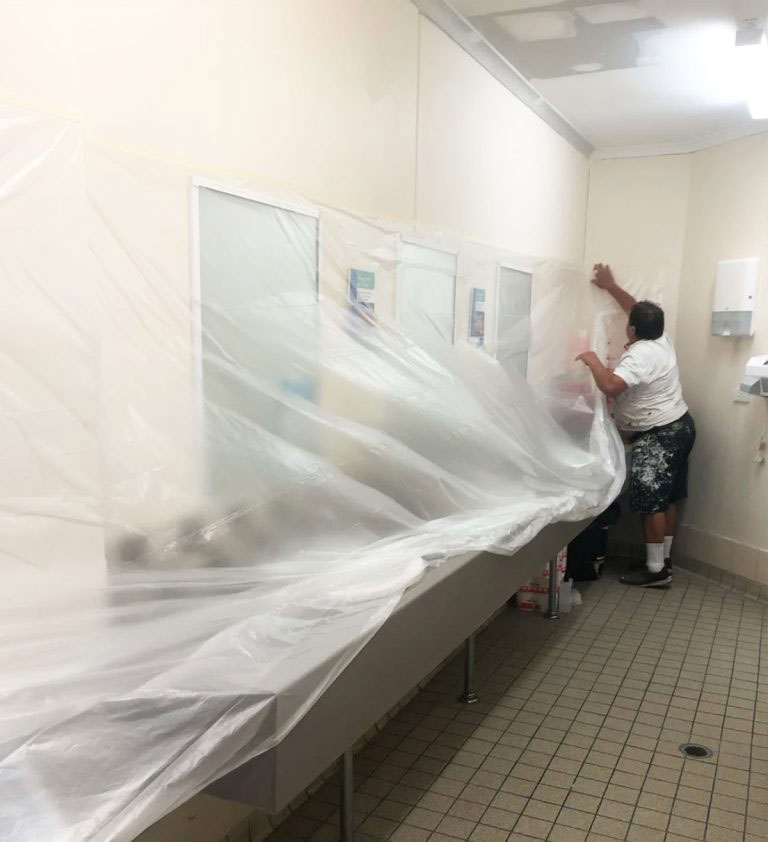 Tony of A & S Poljak Plastering working on a bathroom plastering the ceiling and cornices,